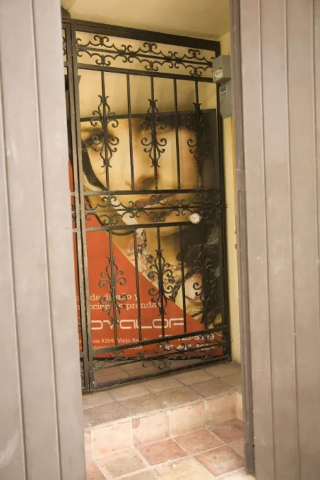 Framed Print : Caribbean, Puerto Rico, Old San Juan. Painting of woman behind wrought-iron grill Framed Print : Caribbean, Puerto Rico, Old San Juan. Painting of woman behind wrought-iron grill