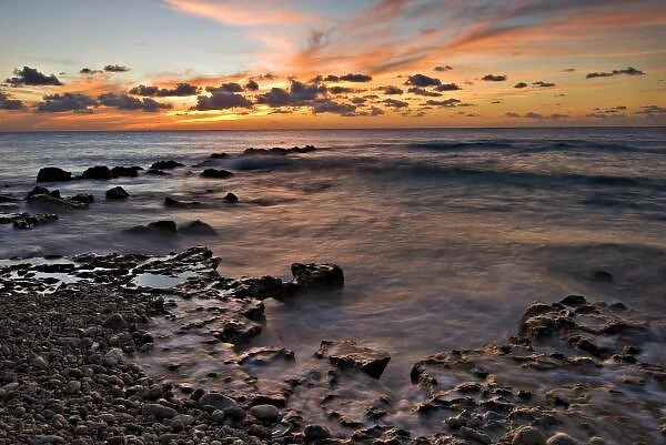 Caribbean Sea, Cayman Islands. Crashing waves at sunset on the shore near George Town