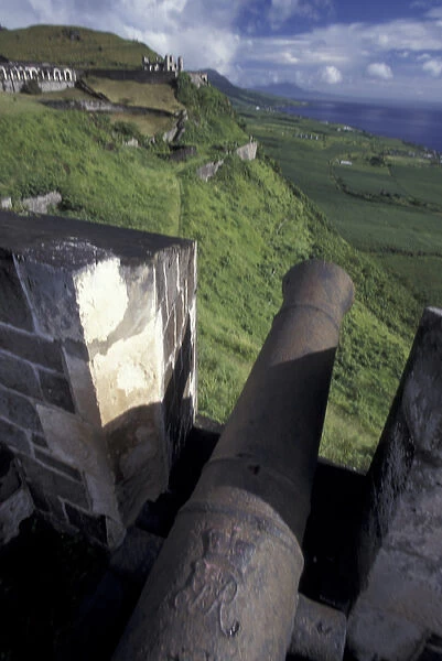 CARIBBEAN, St. Kitts Cannon from old brick fort aiming towrds the ocean