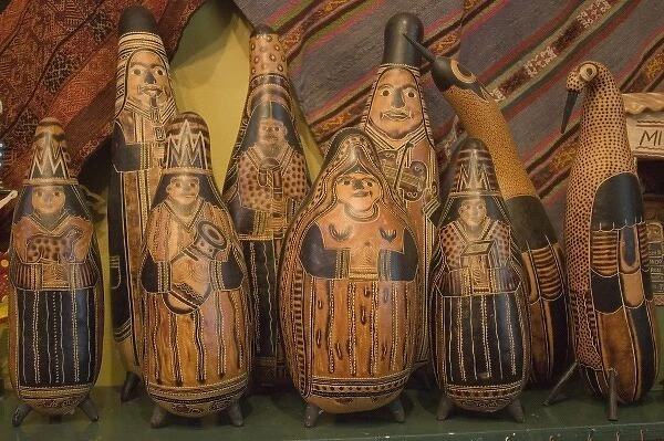 Carved gourds and other folk art on display in shop. Peru, Lima
