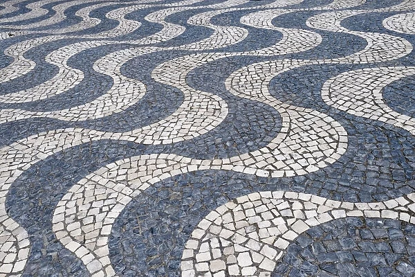 Cascais, Portugal Europe. Typical Portuguese tiled sidewalk in black and white pattern