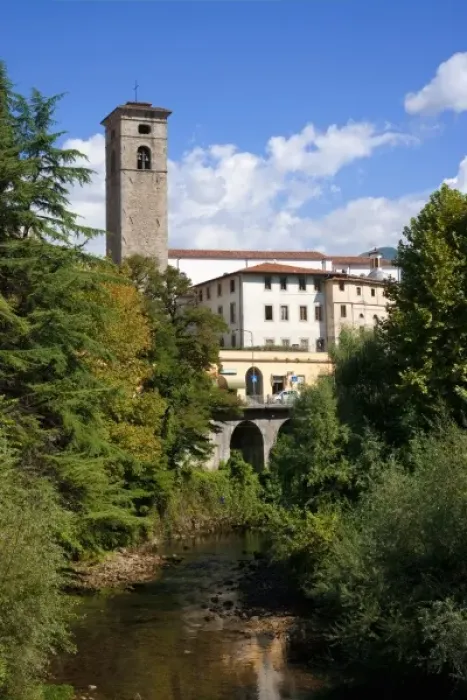 Framed Print : Castelnuovo di Garfagnana, Tuscany, Italy - Old world buildings as seen behind a small waterway