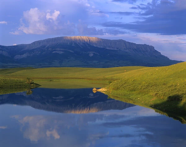 Castle Reef reflects into the Pishkun Canal along the Rocky Mountain Front in Montana