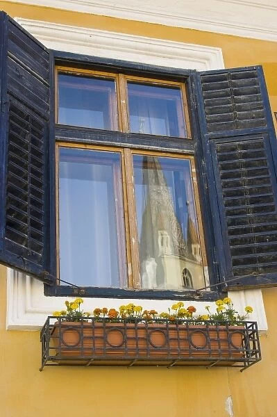 The Cathedral Tower of the Evangelical Church reflecting in a window, Sibiu, Romania