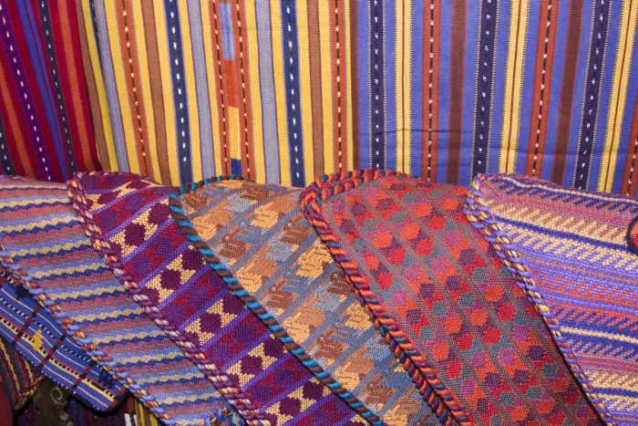 Framed Print : Central America, Guatemala, Antigua. Colorful weavings for sale in shop in Antigua