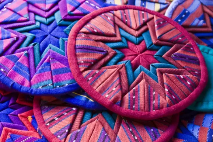 Framed Print : Central America, Guatemala, Antigua. Colorful quilt pieces for sale in shop in Antigua