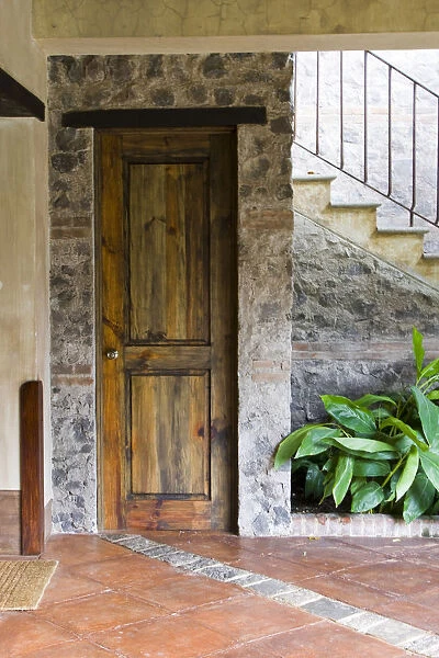 Central America, Guatemala, Antigua. Wooden door in the entryway of a local hotel