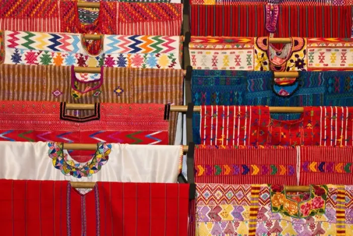 Framed Print : Central America, Guatemala, Antigua. A display of colorful huipils in a shop in Antigua