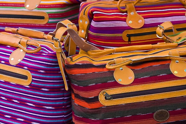 Central America, Guatemala, Chichicastenango. Woven purses for sale on market day