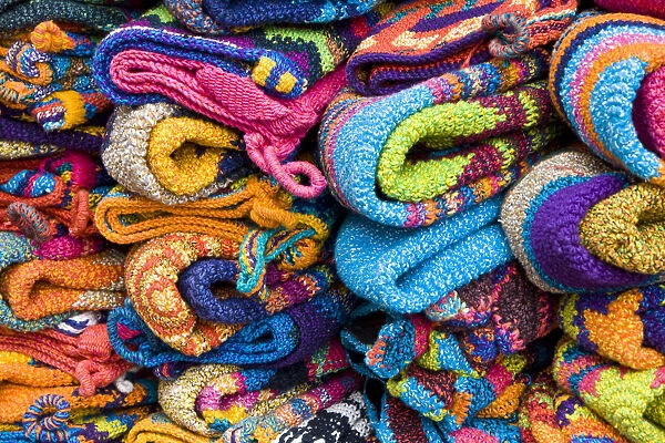 Central America, Guatemala, Chichicastenango. Colorful textiles for sale at the