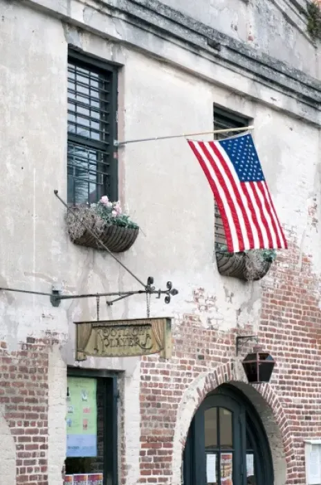 Framed Print : Charleston, South Carolina, USA. An American flag waves in the breeze outside a historic