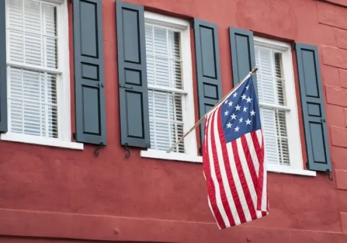 Framed Print : Charleston, South Carolina, USA. An Amerian flag flies over windows on a colorful Framed Print : Charleston, South Carolina, USA. An Amerian flag flies over windows on a colorful