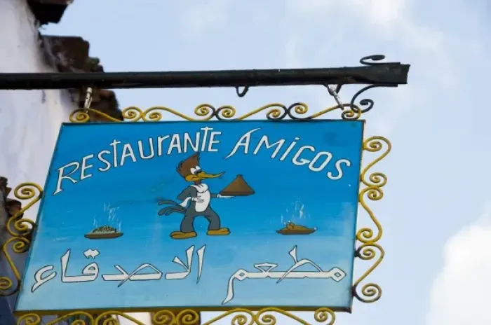 Framed Print : Chefchaouen Morocco restaurant Amigos sign with woodpecker holding a tagine Framed Print : Chefchaouen Morocco restaurant Amigos sign with woodpecker holding a tagine