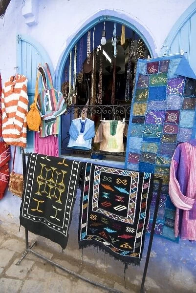 Chefchaouen Morocco tourist shop selling clothes, bags, rugs and wall hangings in the