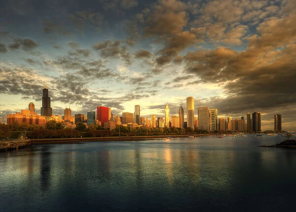 Chicago skyline over lake Michigan as sunrise enters a new day