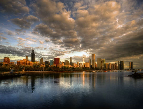Chicago skyline shimmers at sunrise over lake Michigan
