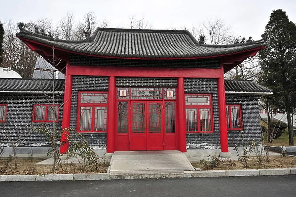 China, Dandong, roofed built structure with a red door and windows
