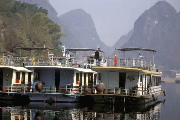 Framed Print : China, Guangxi province. Colorful river tour boats moored along the shore- Li river Framed Print : China, Guangxi province. Colorful river tour boats moored along the shore- Li river