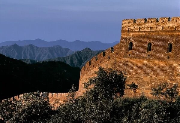 China, Hebei Province, Badaling, The Great Wall. The rising sun colors a tower of