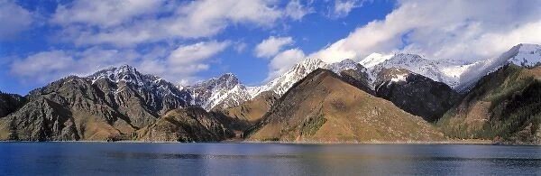 China, Xinjiang, Heavenly Lake. The snow-dappled peaks of Tien Shan Range surround Heavenly Lake