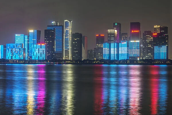 China, Zhejiang, Hangzhou. City skyline at twilight