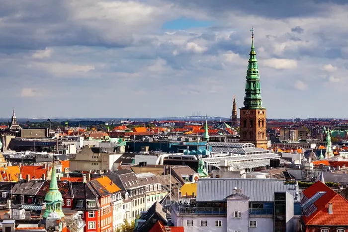 Framed Print : Christiansborg Palace tower and the Nasdaq Copenhagen, formerly known as the Copenhagen Stock Exchange tower. Oresund Bridge in distance, Copenhagen, Denmark