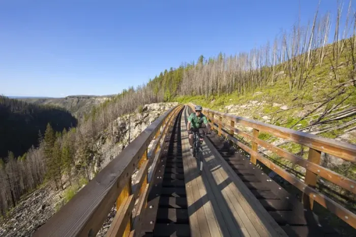 Framed Print : Chuck Haney rides across trestle in Myra Canyon on the Kettle Valley Railway bike