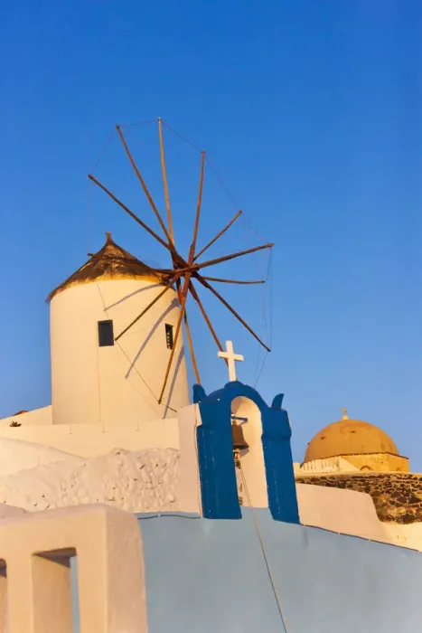Framed Print : Church bell tower and windmill on the coast of Aegean Sea. Oia, Santorini Island, Greece Framed Print : Church bell tower and windmill on the coast of Aegean Sea. Oia, Santorini Island, Greece