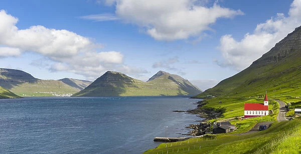 The church in village Husar on Kalsoy, in the background the island of Bordoy and Klaksvik