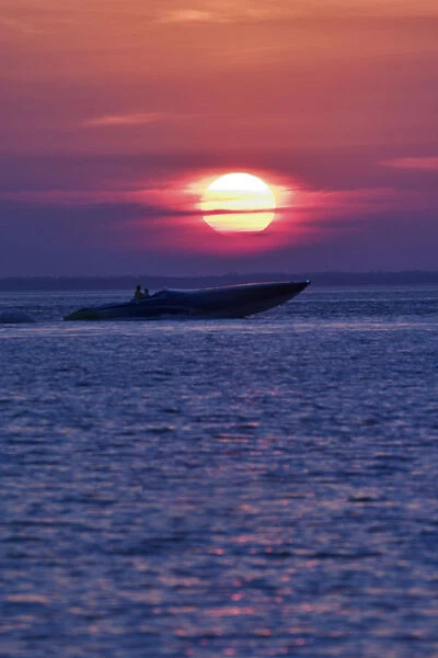 Cigarette boat silhouetted at sunset Fort Meyers, Florida