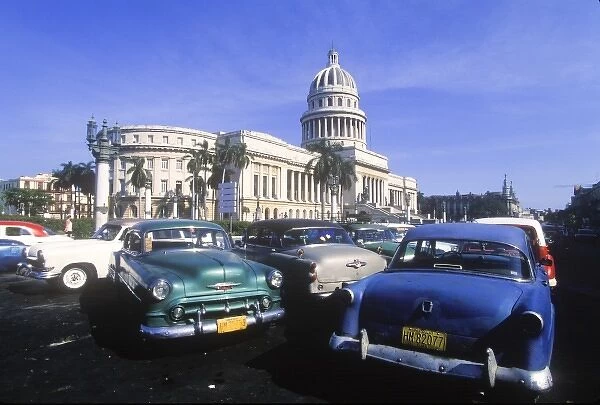 Classic cars parked in front of the Capitolio building modeled after the U. S. Capitol