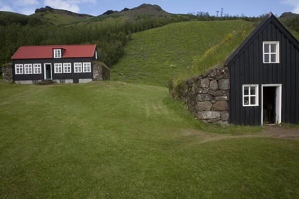 Classic Icelandic rural architecture in sod-roofed workshop (R) and traditional schoolhouse