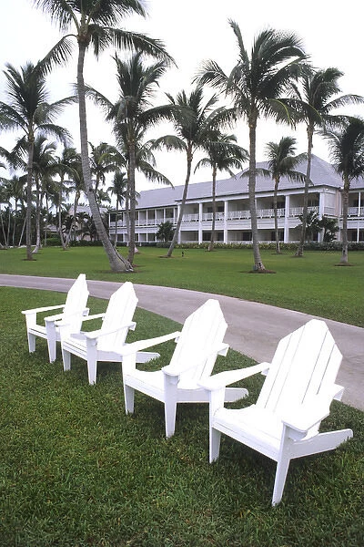 Classic white Adirondack chairs at the Elegant Ocean Club in Paradise Islands Bahamas