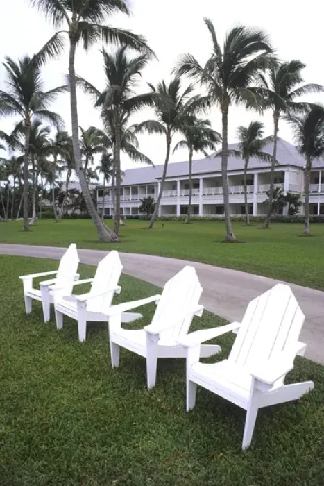 Framed Print : Classic white Adirondack chairs at the Elegant Ocean Club in Paradise Islands Bahamas