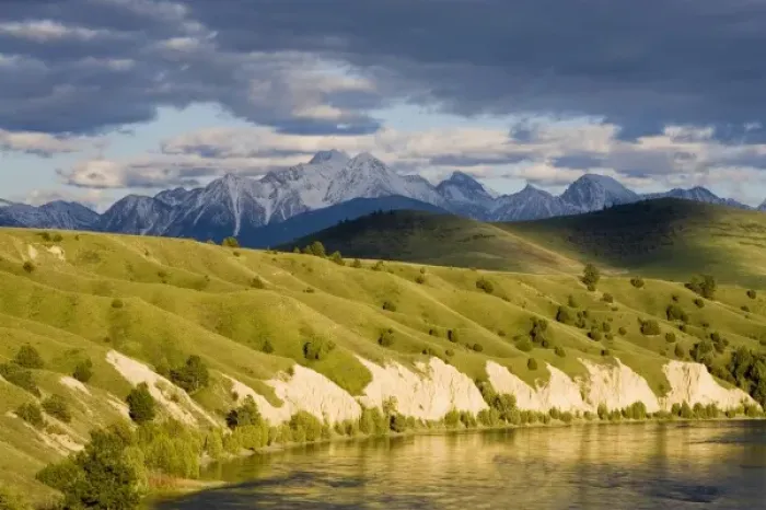 Framed Print : Clay Cliffs reflect into the Flathead River with Mission mountains in the background