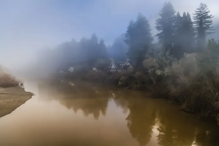Framed Print : The clearing fog from the Russian River with the houses along the riverbank early morning
