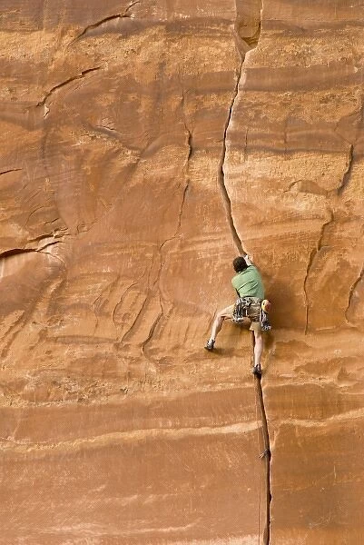 Climbing guide, Moab Desert Adventures in the crux of Miss Kitty likes it that way