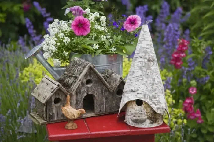 Framed Print : Close-up of bird houses and planter on garden table Framed Print : Close-up of bird houses and planter on garden table