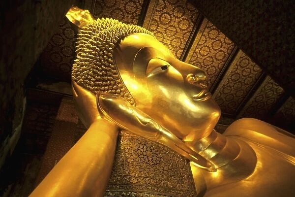 Close-up of gold Reclining Buddha in Grand Palace in Bangkok Thailand