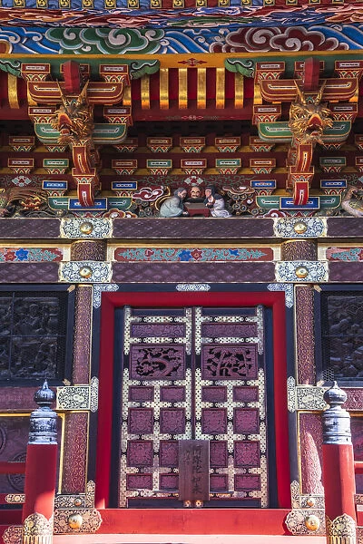 Close-up view of the colorful door and roof of a temple