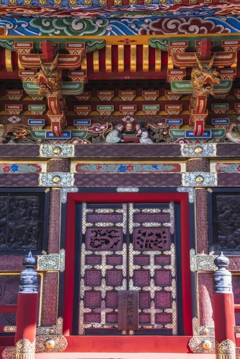 Framed Print : Close-up view of the colorful door and roof of a temple