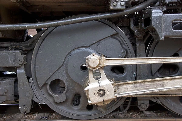 Close up detail view of a steam locomotive drive wheel