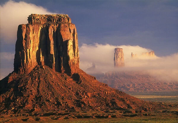 Clouds dance in the buttes in Monument Valley, on the Arizona, Utah border