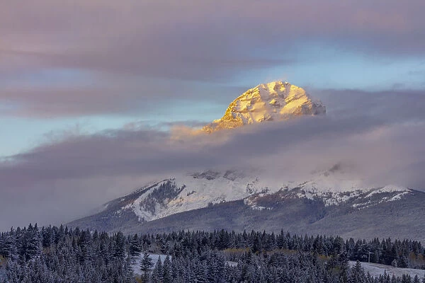 Clouds envelope Crowsnest Mountain at Crowsnest Pass, Alberta, Canada