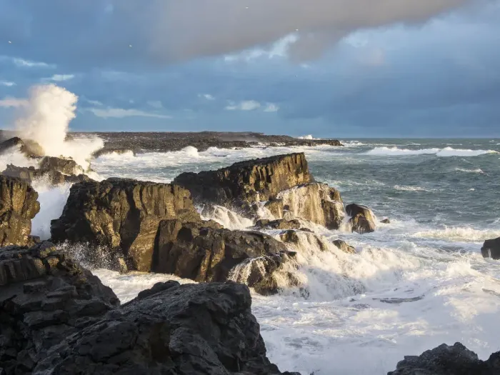Framed Print : Coastline at Brimketill during stormy conditions at sunset