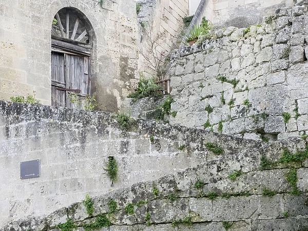 Cobblestone steps leading to the entrance of a Sassi home in the old town of Matera