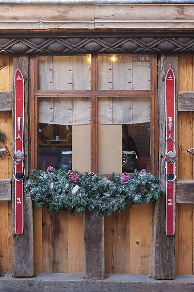 Colmar, France. Old town Colmar adorned with Christmas decoration. Old skis decorate a rustic cafe with a ski theme