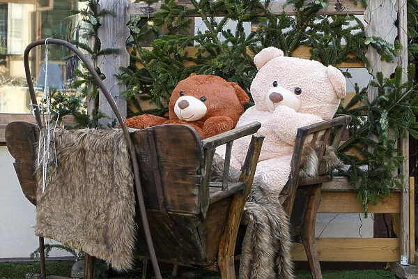 Colmar, France. Old town Colmar adorned with Christmas decoration. Cozy teddy bears in old wooden sleigh