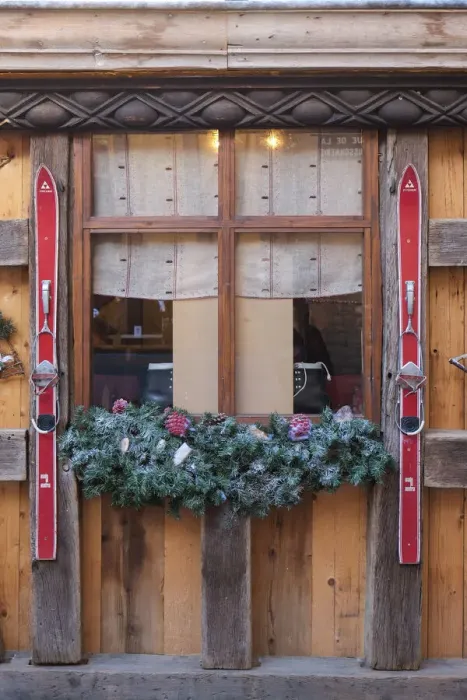 Framed Print : Colmar, France. Old town Colmar adorned with Christmas decoration. Old skis decorate a rustic cafe with a ski theme