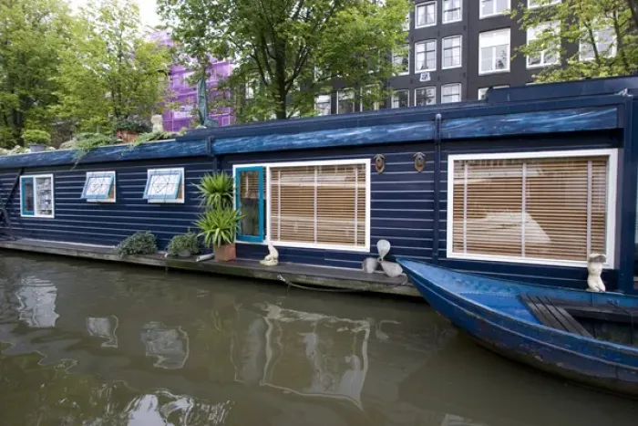 Framed Print : a colorful blue houseboat with matching row boat on a canal Framed Print : a colorful blue houseboat with matching row boat on a canal